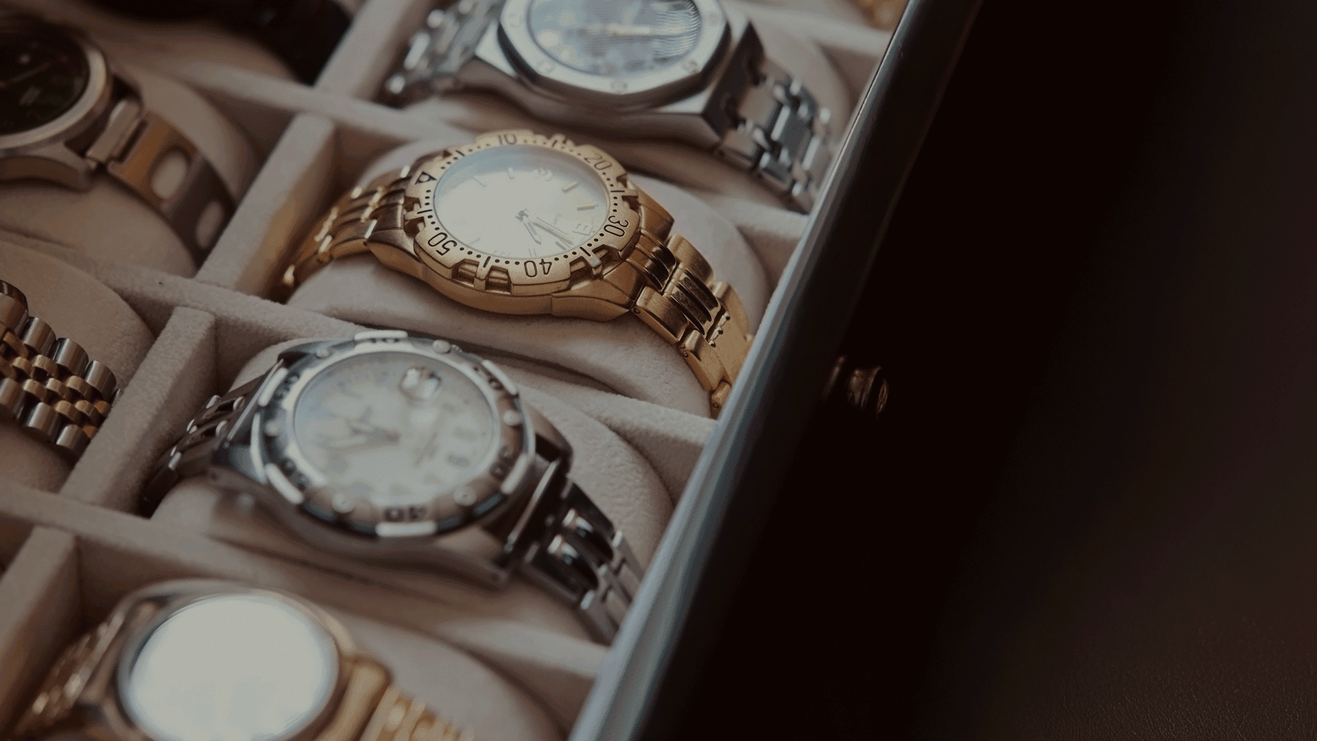 watch collection close up in a tan coloured watch box