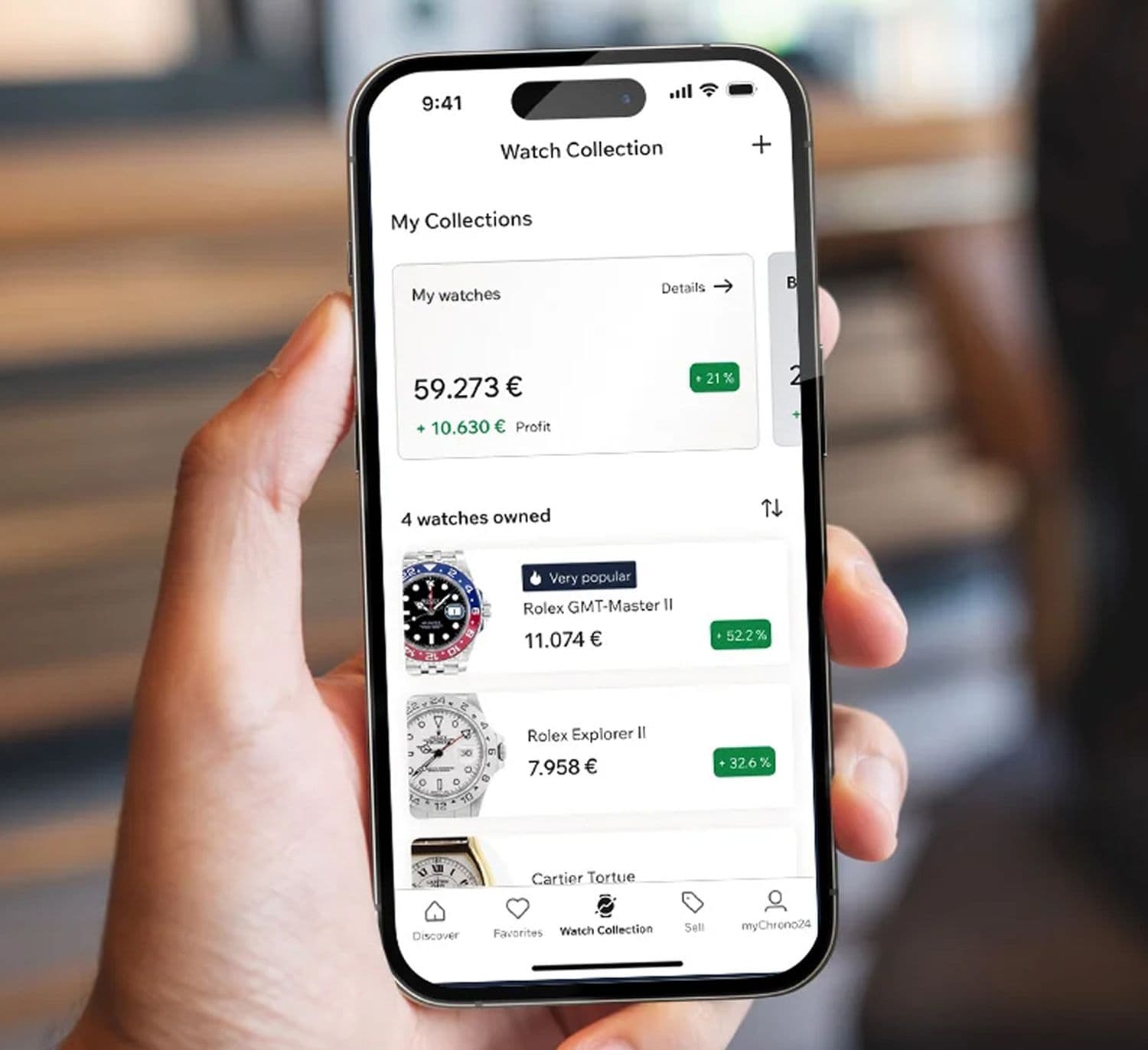 hand holding a smartphone with the watch collection open